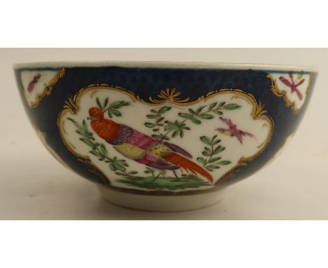 An 18th century Worcester slop bowl, the scale blue ground decorated with reserve panels of insects and fabulous birds, with 