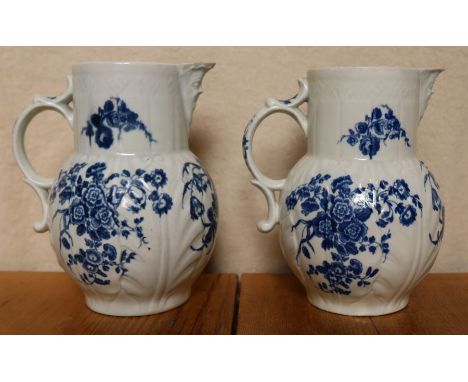 Two 18th century Worcester leaf moulded jugs, the sparrow beak jug moulded with a mask, the body decorated with flowers and l