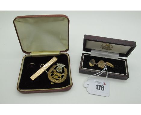 A Pair of 9ct Gold Oval Cufflinks, the part engine turned panels on chain connections, in a fitted case; together with a 'Pio