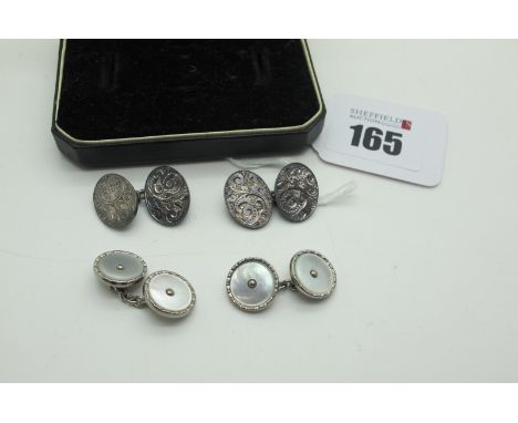 A Pair of Victorian Chester Hallmarked Silver Cufflinks, the oval panels leaf scroll engraved, on chain connections, Chester 