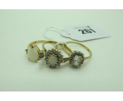 A Modern Dress Ring, claw set pear shape centre, within claw set highlights, between plain shoulders, stamped "375" (finger s