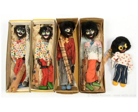 Pelham Puppets collection of five vintage "Golliwog" marionettes, two are within brown boxes, two are within yellow boxes, on