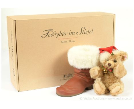 Steiff Teddy Bear in a Boot, white tag 670862, LE 4000, comprising fawn mohair Christmas teddy bear wearing Santa hat, in res