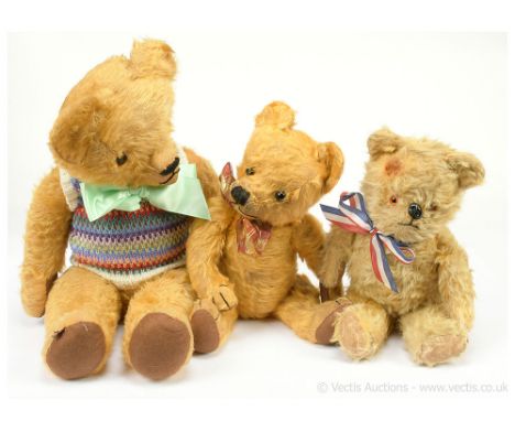 Three vintage teddy bears, including: (1) British golden mohair teddy bear, amber and black plastic eyes, black metal dog nos