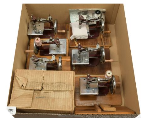 Essex (UK) collection of six miniature children's vintage Sewing Machines, maroon cast iron, crank handle driven, one is boxe