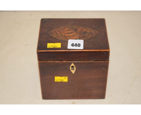A small Georgian inlaid mahogany tea caddy, with inlaid shell motif on the lid, opening to reveal a formerly tin-lined interi