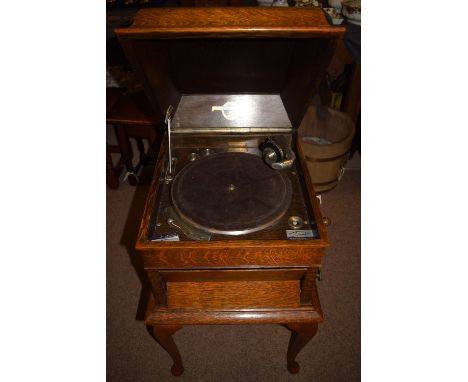 A Columbia wind-up vintage 'Grafonola' gramophone in oak case on associated stand.