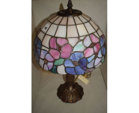 A table lamp with Tiffany style glass shade.