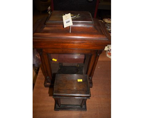 A 19th Century mahogany bracket clock case, the flared cornice above a rectangular glazed panelled door, flanked by turned ha