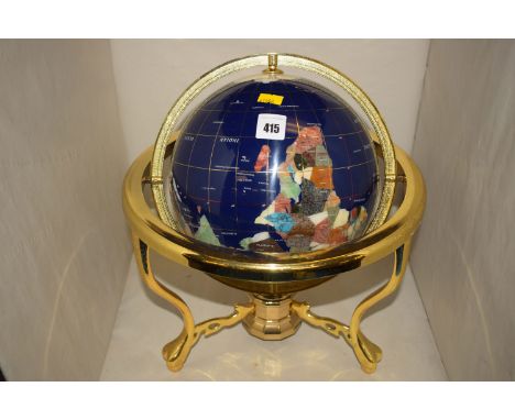 A terrestrial globe inlaid with various mineral samples, in brass gimbal, fitted a compass in the base.