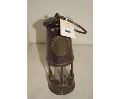 The Protector Lamp & Lighting Co., Type SL miner's lamp, with steel bonnet and brass base.