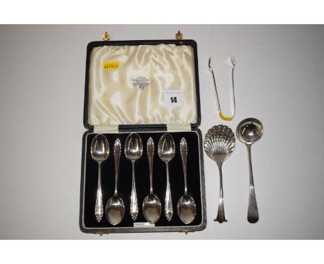 A set of six silver teaspoons in fitted case; a pair of sugar tongs; a sugar sifting spoon; and a Georgian toddy ladle.