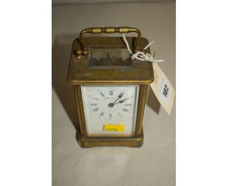 A brass cased carriage alarm clock, with retailer J. Bennett, Paris, the white enamel roman dial with subsidiary dial below, 