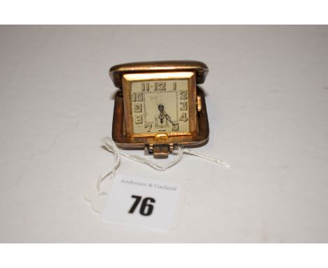 A silver gilt travelling clock, the Art Deco style numerals in engine turned case, by S.S.M., Birmingham 1934.