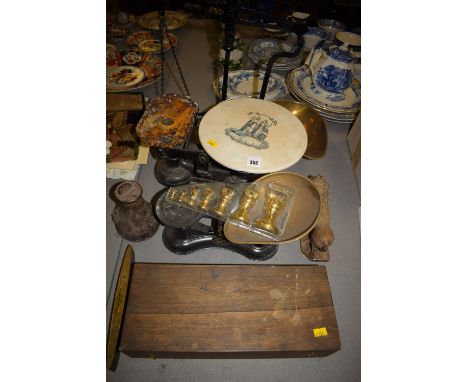 A cast iron kitchen balance with ceramic plate; a beam balance with brass scoop; a cast iron weight; a spirit level; another 