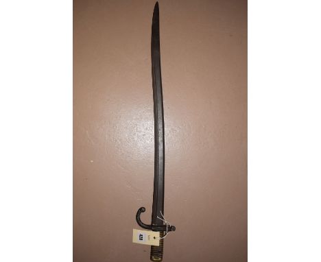 A 19th Century French bayonet with curved single-edged fullered blade and brass hilt (no scabbard).