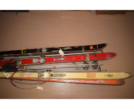 Three pairs of Vintage skis, by Arlberg Olympique; Elan; and Combi junior together with ski poles.