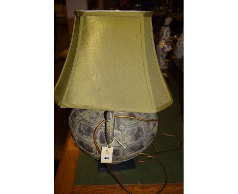 A modern large Oriental style globular metal table lamp with stylized dragon handles, fitted a green shade, on black plinth b