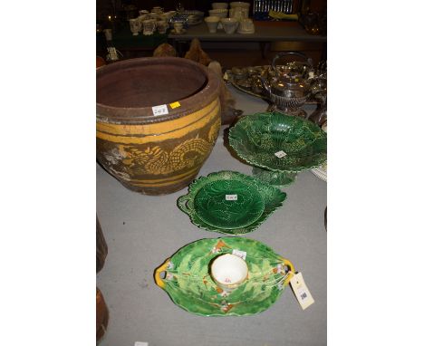 A two-handled Majolica oval dish with raised leaf pattern decoration; a Wedgwood style green glazed leaf pattern fruit stand;