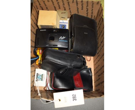 An Olympus MJU compact camera; a Miranda camera and other photographic items, in a box.
