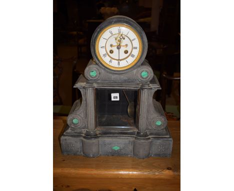 A Victorian slate mantel clock, inset with malachite, fitted white enamel dial and skeleton escapement.