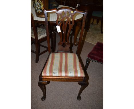 A set of four reproduction Chippendale style mahogany dining chairs, with pierced vase-shaped splats, the drop-in seats uphol