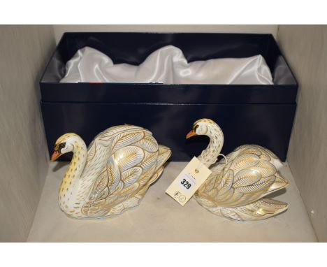 A pair of large Royal Crown Derby ceramic paperweights in the form of swans, titled 'The Royal Swans William & Katherine', Li