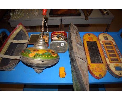 A Big Fun Toy: a lifeboat and towing barge; a tin plate spinning wheel decorated with a train, horse, a butterfly, etc; paint