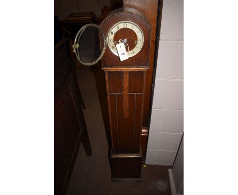 A 1930's oak cased Grandmother clock; together with a similar mantel clock.