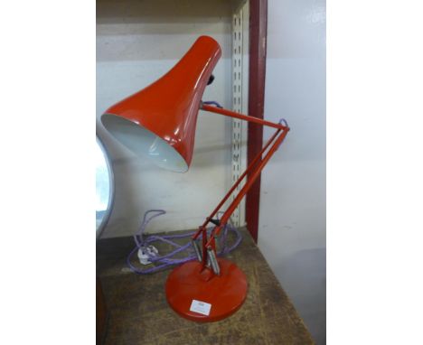 A red metal anglepoise desk lamp 
