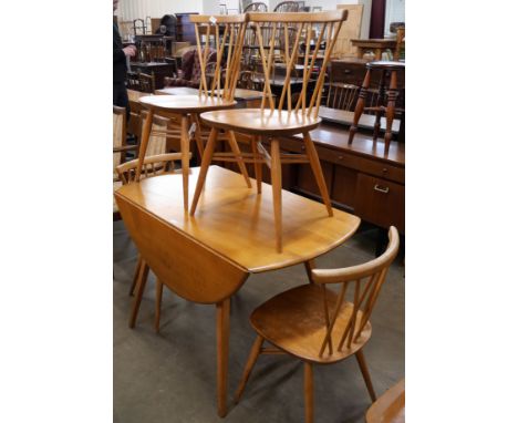 An Ercol Blonde elm and beech Windsor drop leaf table and four candlestick back chairs 