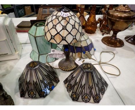 Four Tiffany style light shades and a Tiffany style lamp. All electrical items in this lot have been PAT tested for safety an