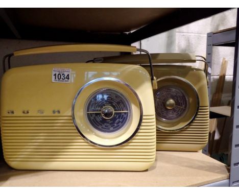 Two Bush radios, model TR82, one blue and one burgundy with cables, working at lotting. All electrical items in this lot have