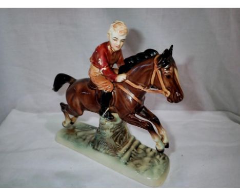 German ceramic horse with child rider, losses to paint to boy and one leg and ear reglued, H: 19 cm. UK P&amp;P Group 2 (£20+
