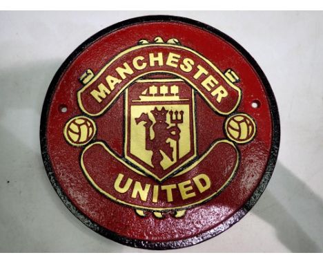 Cast iron Manchester United plaque. D: 25cm. UK P&amp;P Group 1 (£16+VAT for the first lot and £2+VAT for subsequent lots) 