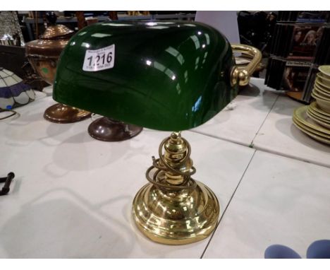 Brass desk lamp with green glass shade. All electrical items in this lot have been PAT tested for safety and have passed. Thi