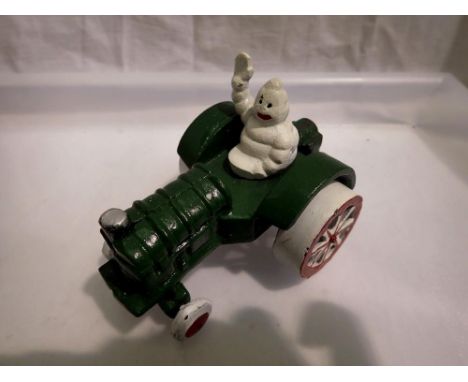 Cast iron Michelin man on tractor, H: 80mm UK P&amp;P Group 1 (£16+VAT for the first lot and £2+VAT for subsequent lots) 