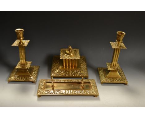 A late 19th/early 20th century four piece desk set comprising inkwell, pair of candlesticks and pen tray (4)