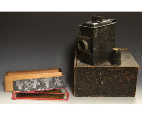 A portable candle power black tin plate magic lantern, boxed; a set of fifteen hand coloured slides, Oriental figures etc 