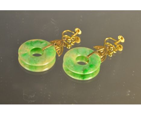 A pair of jade and 9ct gold carved dish earrings, each carved with a band of flowers, unmarked