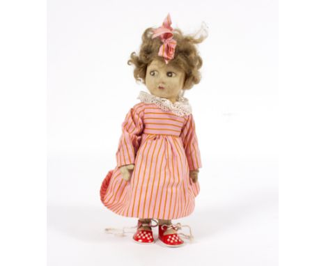 A Lenci style doll with jointed pressed felt body, side glancing eyes, wearing a pink striped dress