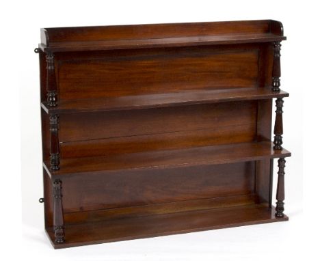 A mahogany hanging shelf with turned supports to the graduated shelves, 91.5cm wide