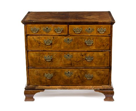 A William and Mary walnut chest of three long and two short drawers, having a quarter veneered top inlaid herringbone, raised