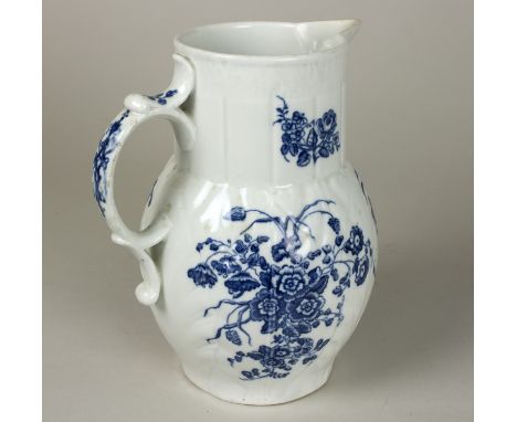 A Caughley blue and white cabbage-leaf moulded jug, circa 1780, printed with flowers, mask spout, 18.5cm high   Condition Rep