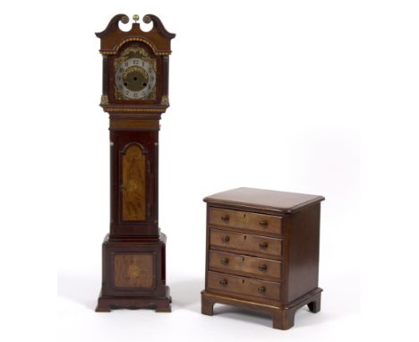 A miniature longcase clock case, 89cm high and a mahogany chest of four drawers, 30cm wide