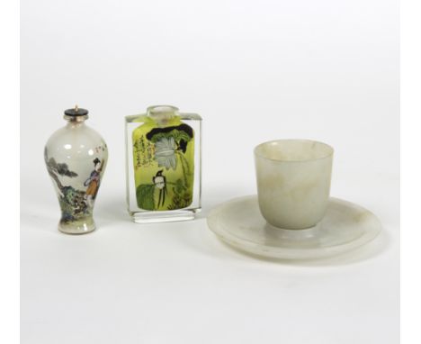 A pale celadon jade tea bowl and saucer, the saucer 10.5cm diameter and two Japanese snuff bottles