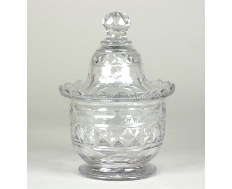 A small Irish glass lidded jar, cut with ovals and diamonds, 14.5cm high  Condition Report: Tiny chip to finial on cover, bow