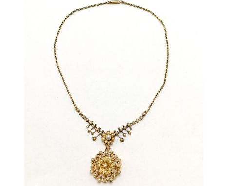 Unmarked (touch tests as 18ct) gold pendant / brooch (lacks pin) on an unmarked (touch tests as 15ct) gold pearl set necklace