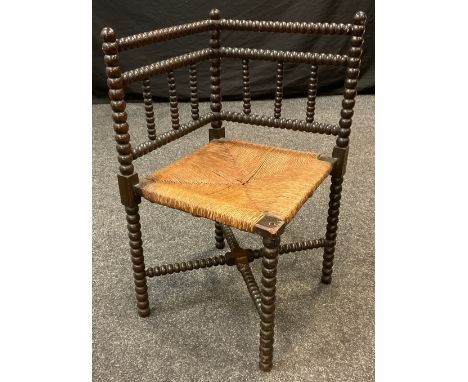 An Arts and Crafts bobbin turned corner chair, rush seat, 71cm high, c.1890. 