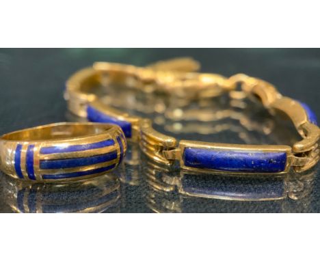 A Middle eastern/Egyptian lapis lazuli inset gold coloured metal bracelet, indistinctly marked,  catch broken, 19cm long, 22g